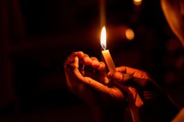 person-holding-lighted-candle-1393530