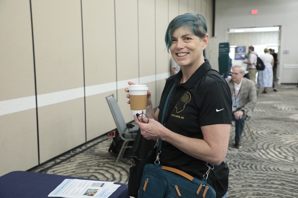conference attendee holding a cup of coffee.