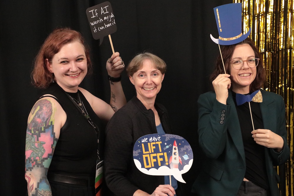 A group of conference attendees posing in the photo booth.