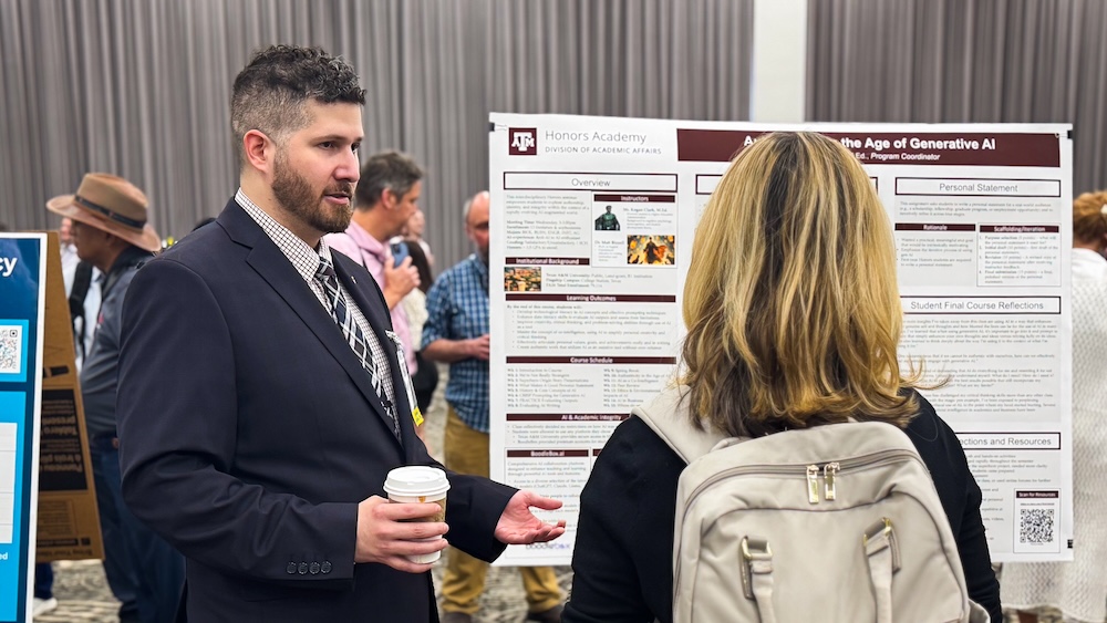 A presenter and an attendee are having a discussion during a poster session.